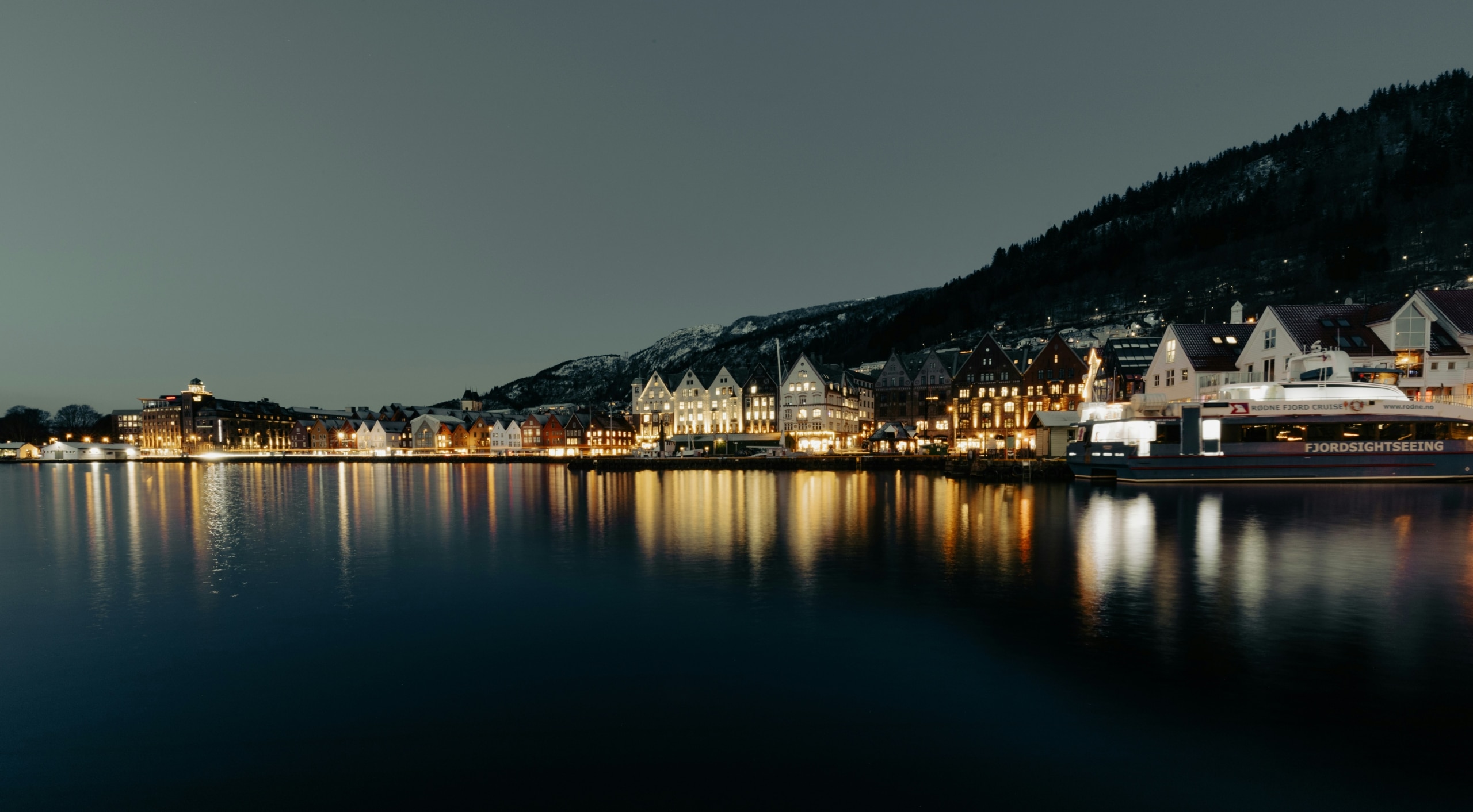 a town on the shore of a lake at night