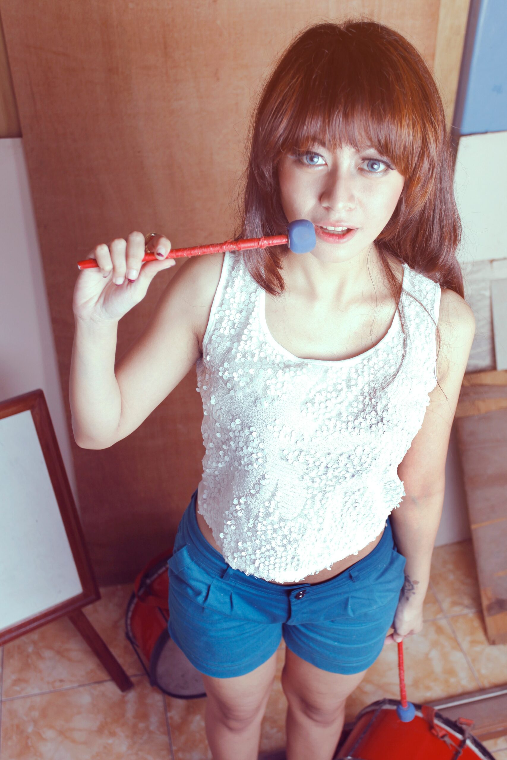 a woman brushing her teeth with a toothbrush